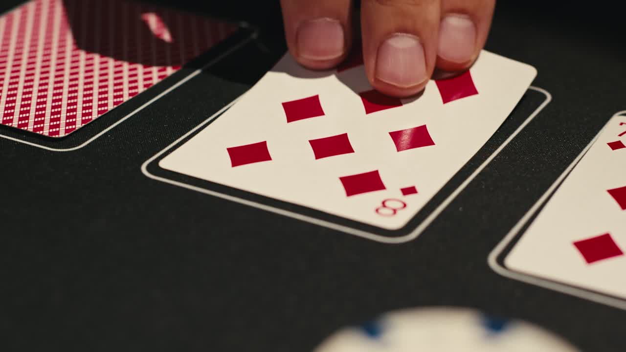 Hands managing poker chips on green table, reflecting intense poker gameplay with the element of chance and skill