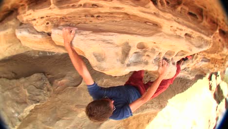 Fisheye-Of-A-Young-Rockclimber-Gingerly-Maneuvering-His-Way-Along-A-Rockface