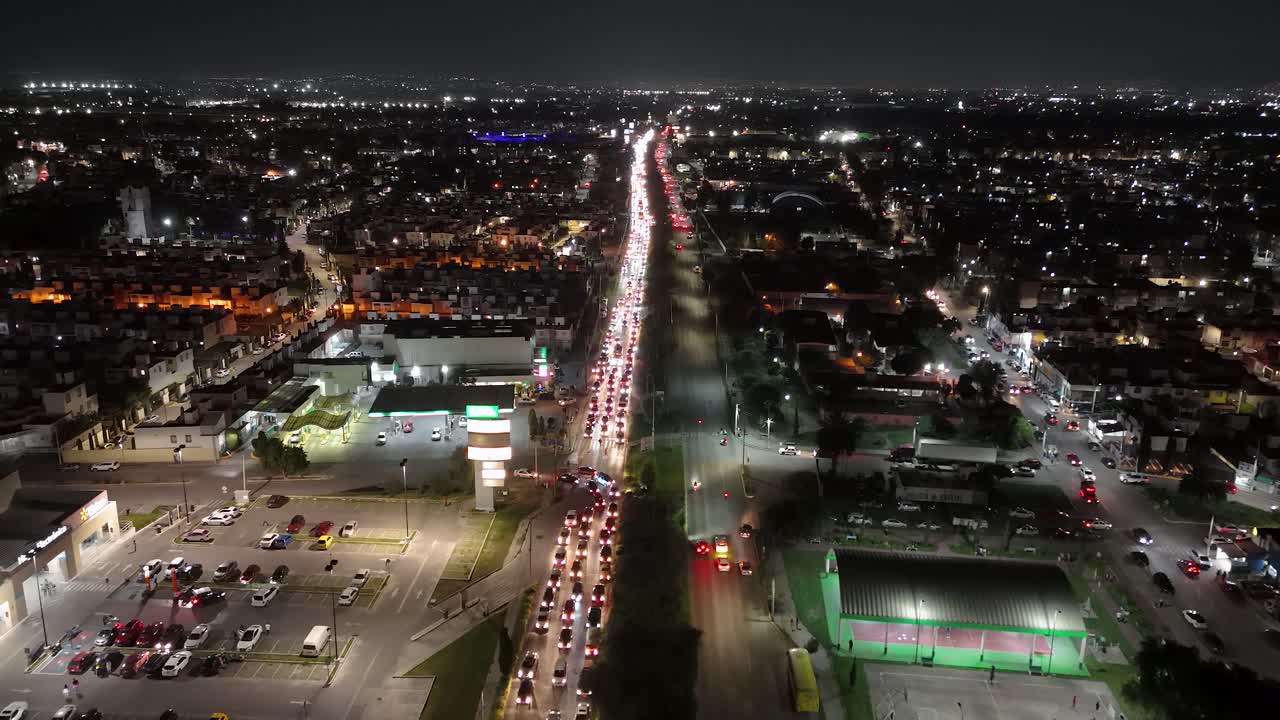 Nighttime drone shot over Avenida Huehuetoca, an access road to the municipality of Cuautitlán Izcalli, State of Mexico, filled with heavy vehicle traffic as the local population returns home