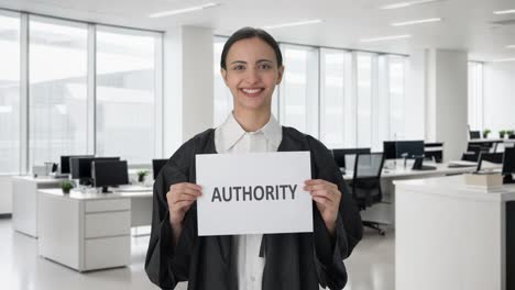 happy indian female lawyer holding authority banner