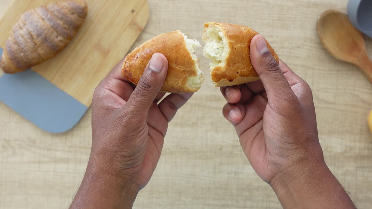 Person holding a filled bread pastry