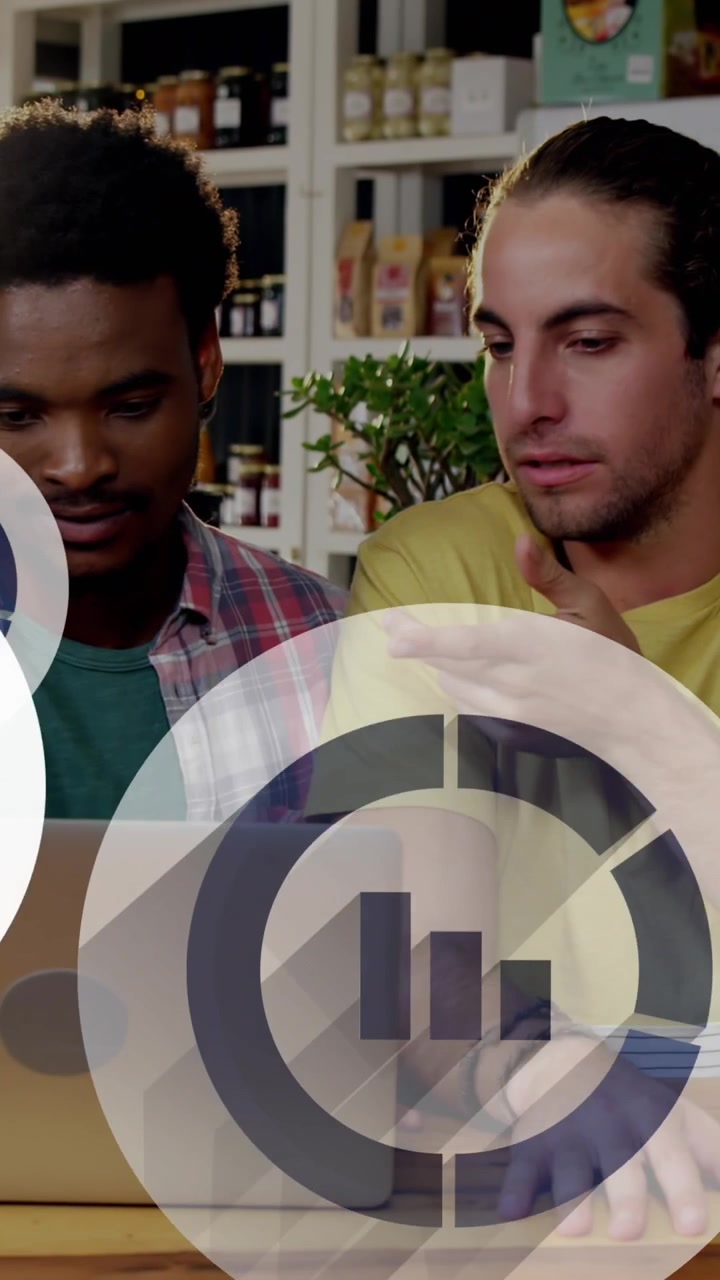 Animation of graph icons over diverse friends watching video on laptop in cafes