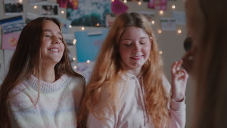 happy teenage girls taking photos together using instant photo camera best friends hanging out at home on weekend enjoying friendship