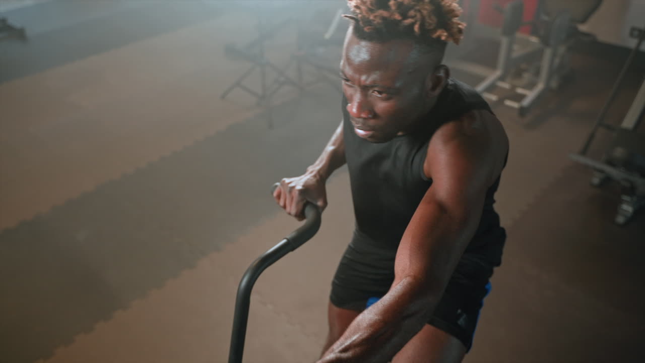 Man Working Out on Exercise Bike in Gym