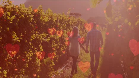 animation of digital hearts over caucasian couple walking on plantation