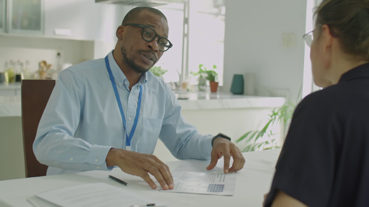 Black Engineer Shaking Hands and Talking with Businesswoman