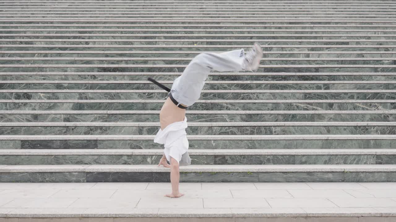 Breakdancer performing various moves on urban steps