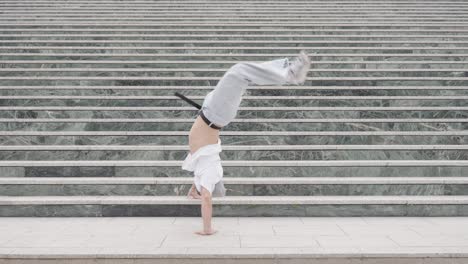 breakdancer performing various moves on urban steps