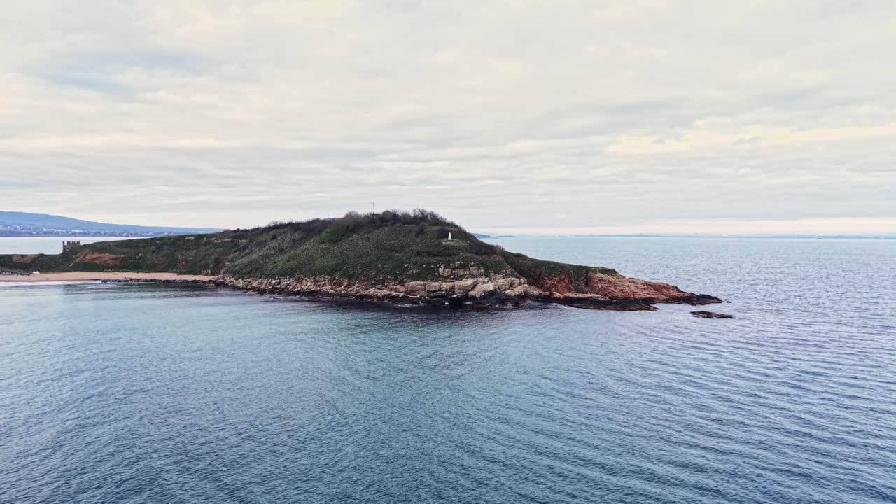 Aerial view of a serene coastal island with calm waters