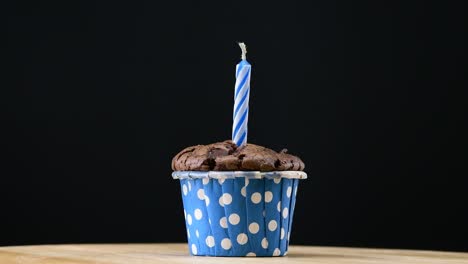 cupcake party with candle on blue background cinemagraph seamless loop.