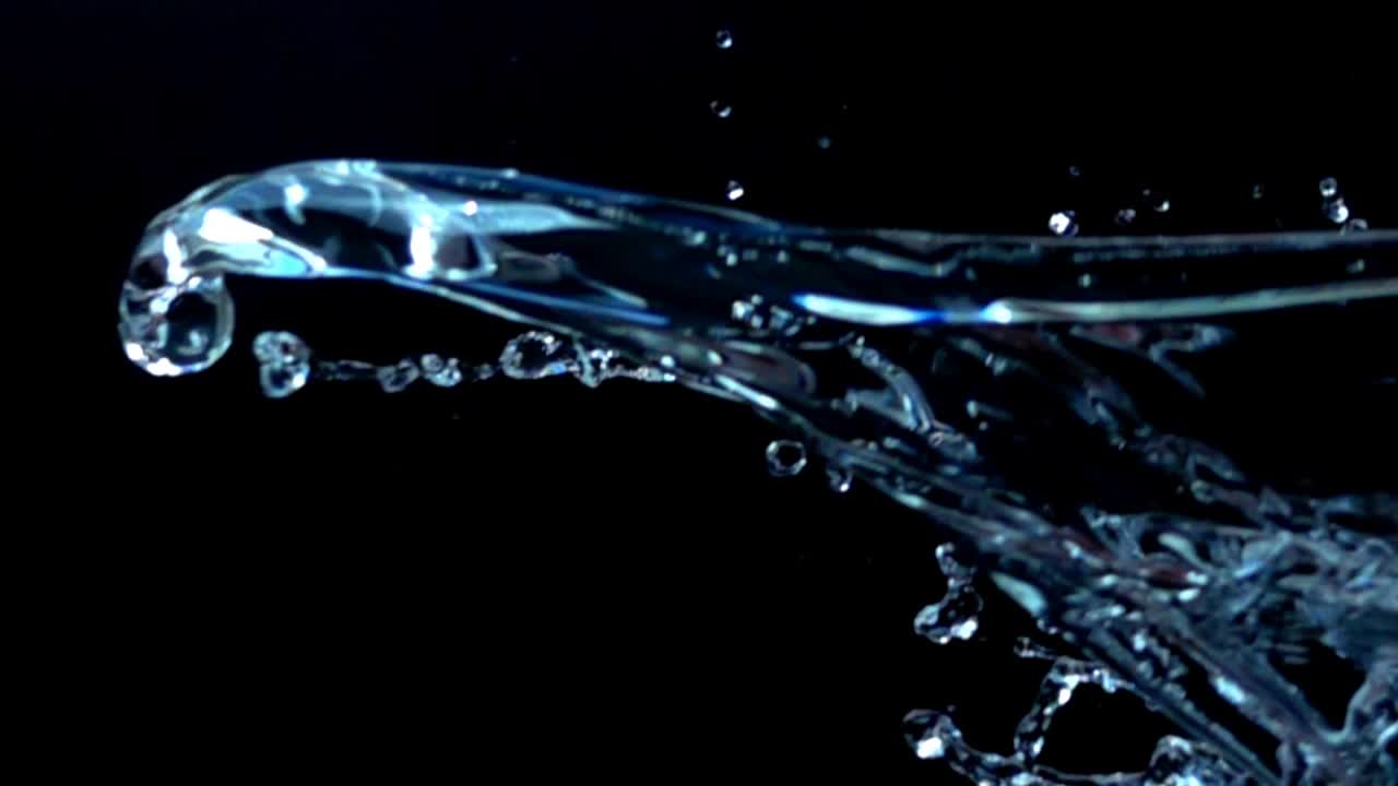 Water on a black background. Slow motion