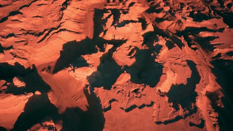 mars - aerial, inhospitable red mountainous desert landscape in middle of nowhere, tilt down