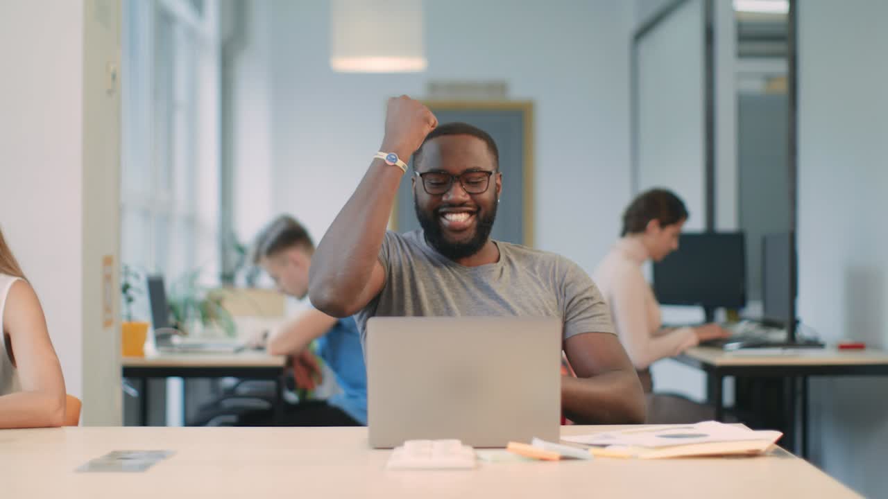 Freelancer professional celebrating business success in office. Happy worker