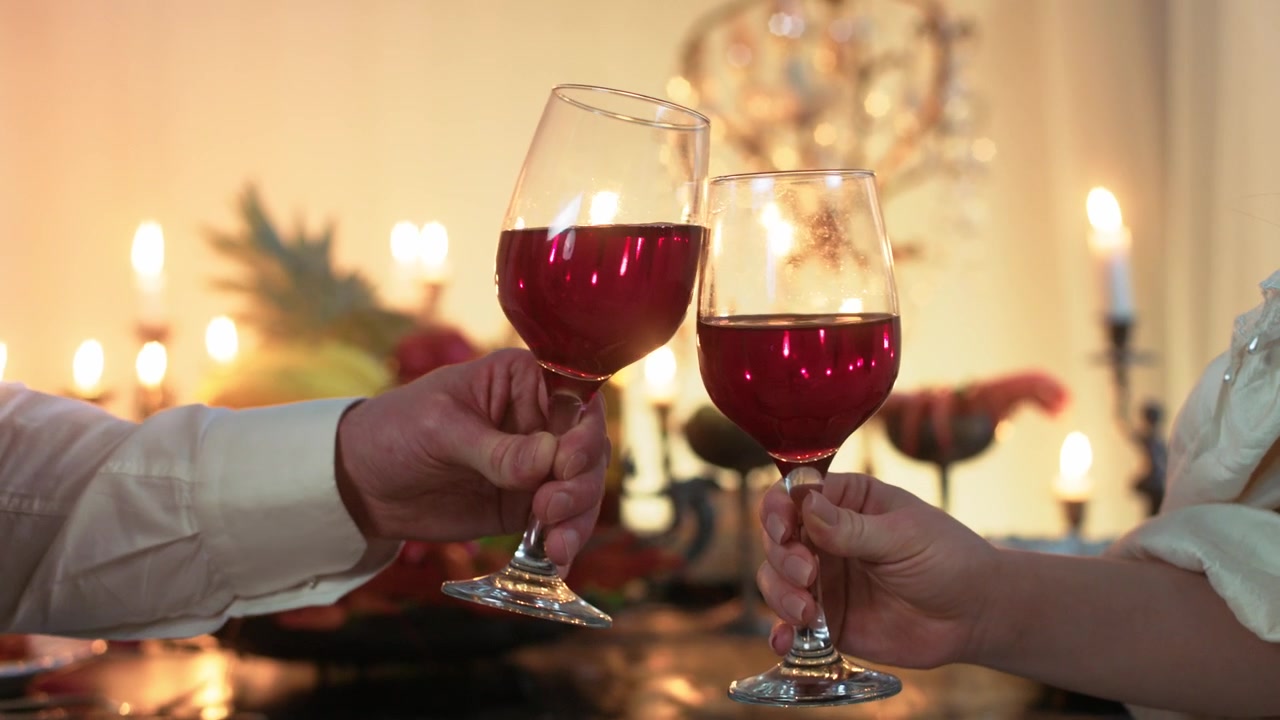 Couple Toasting with Red Wine Glasses at a Festive Dinner