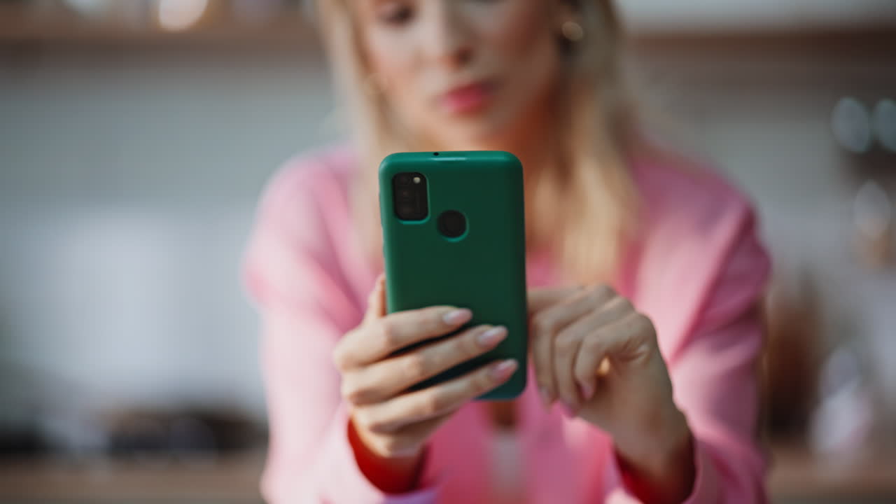 Woman finger swiping mobile phone in apartment closeup. Girl scrolling screen