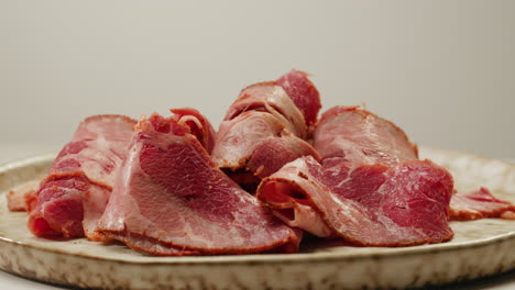 sliced cured meat on a plate