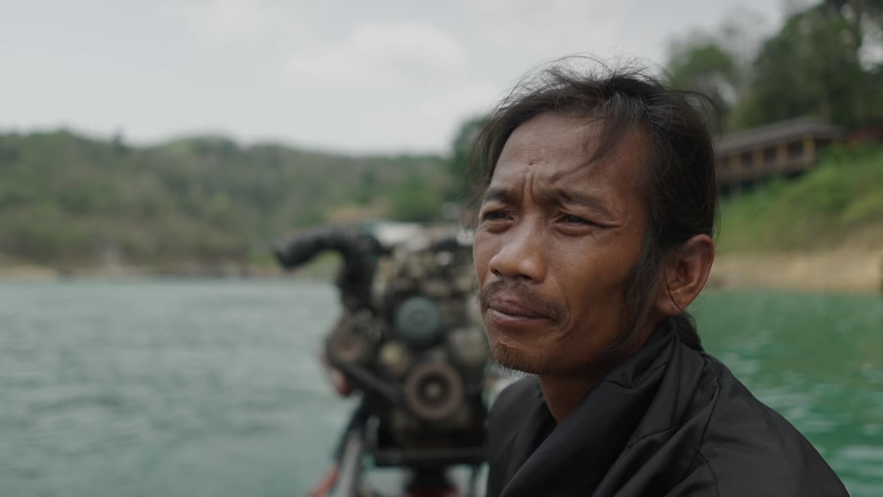 Man on a Boat on a Scenic Lake