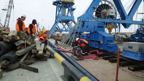 port workers loading cargo onto barge