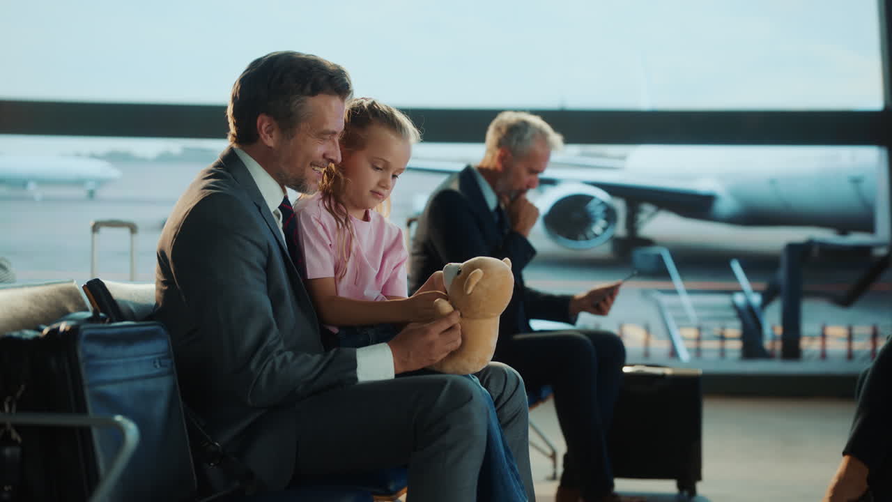 Father and Daughter Waiting at Airport