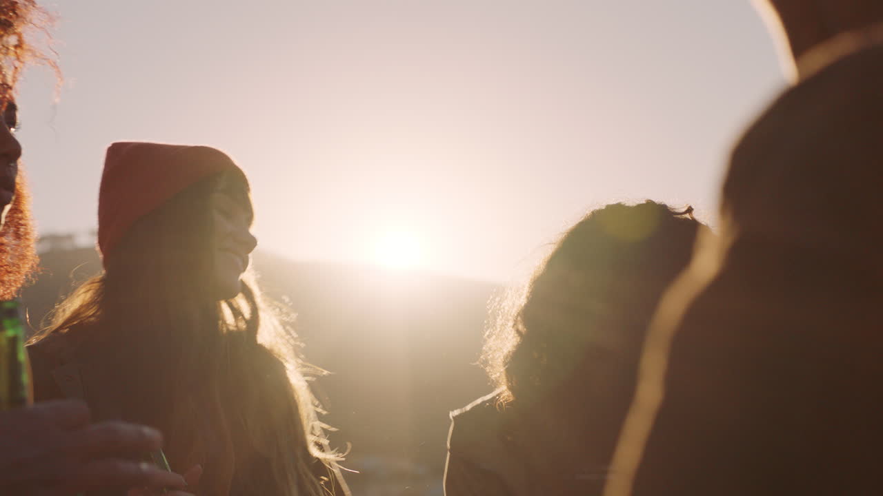 счастливые друзья танцуют, празднуют на крыше на закате, наслаждаются вечеринками в выходные, веселятся, общаются, гуляют, пьют алкоголь.