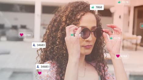 social media likes and follower counts animation over woman adjusting sunglasses