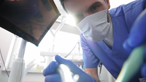 Low-angle-view-of-dentist-doing-his-work