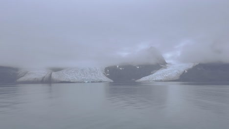 glacier in the arctic sea north of the svalbard archipelago on a foggy day