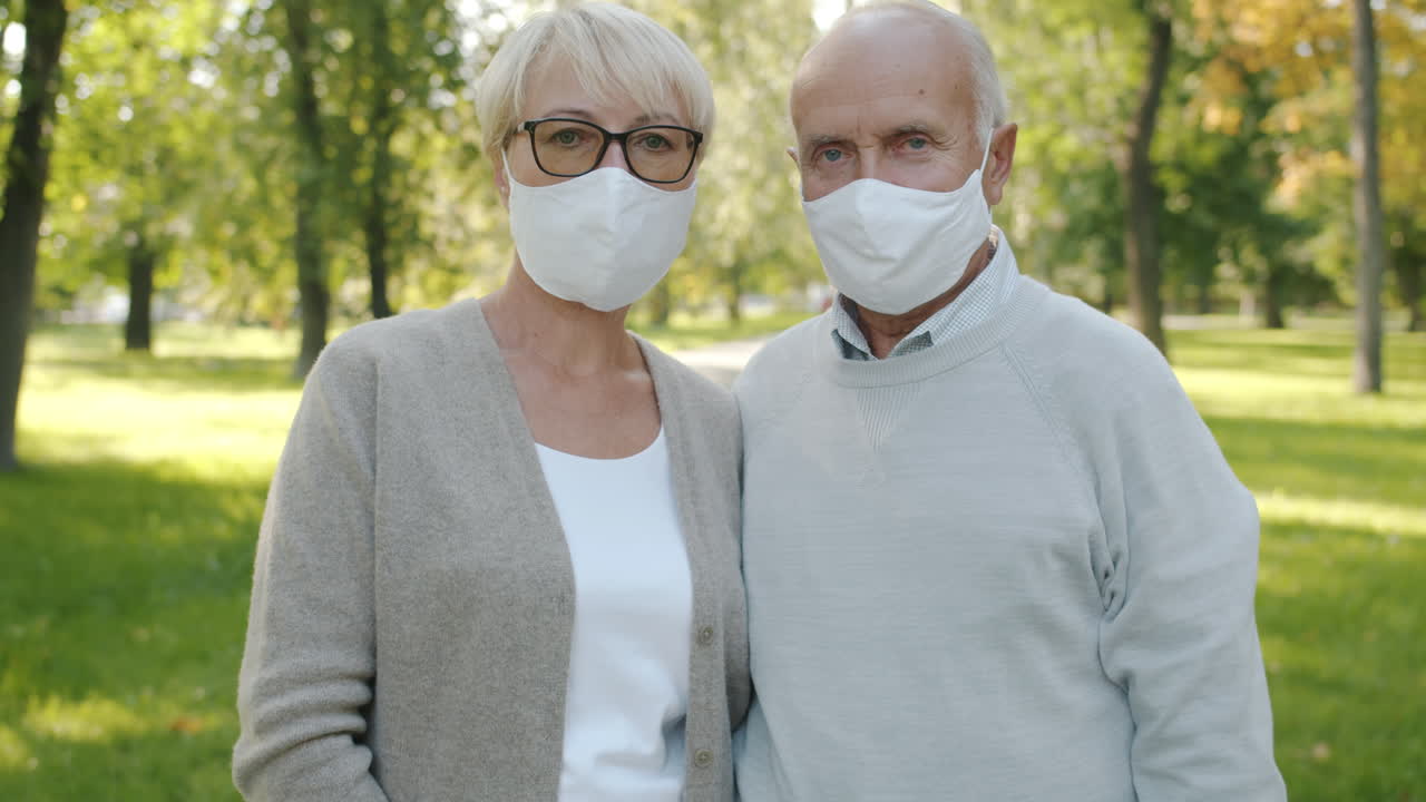 Elderly Couple Wearing Masks in a Park