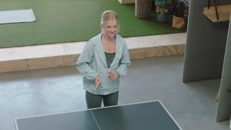 mujer de negocios feliz jugando al ping pong en la oficina disfrutando de la diversión competitiva ganando colega usando teléfono inteligente compartiendo juego en las redes sociales