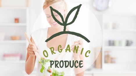 Animation-of-organic-produce-text-in-green,-over-smiling-woman-tossing-fresh-salad