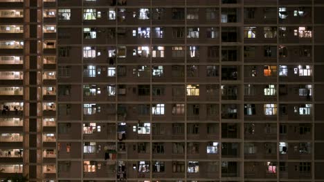 a nighttime view of a crowded high-rise public housing apartment building in hong kong