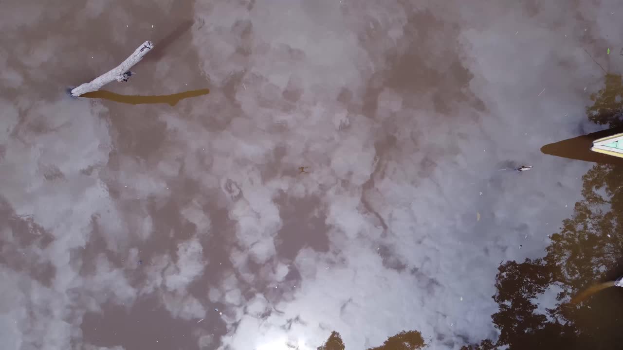 Bird's eye view of Fishermen on the Amazon River - aerial drone shot