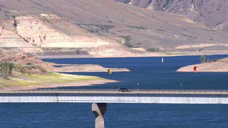 cars passing a bridge over a reservoir in gunnison, colorado