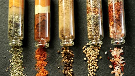 various spices spilled out of jar 4k