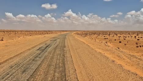 Wind-blowing-sand-on-desert-road-in-Tunisia