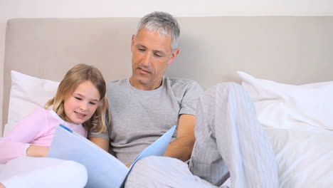 Father-and-daughter-reading-a-book