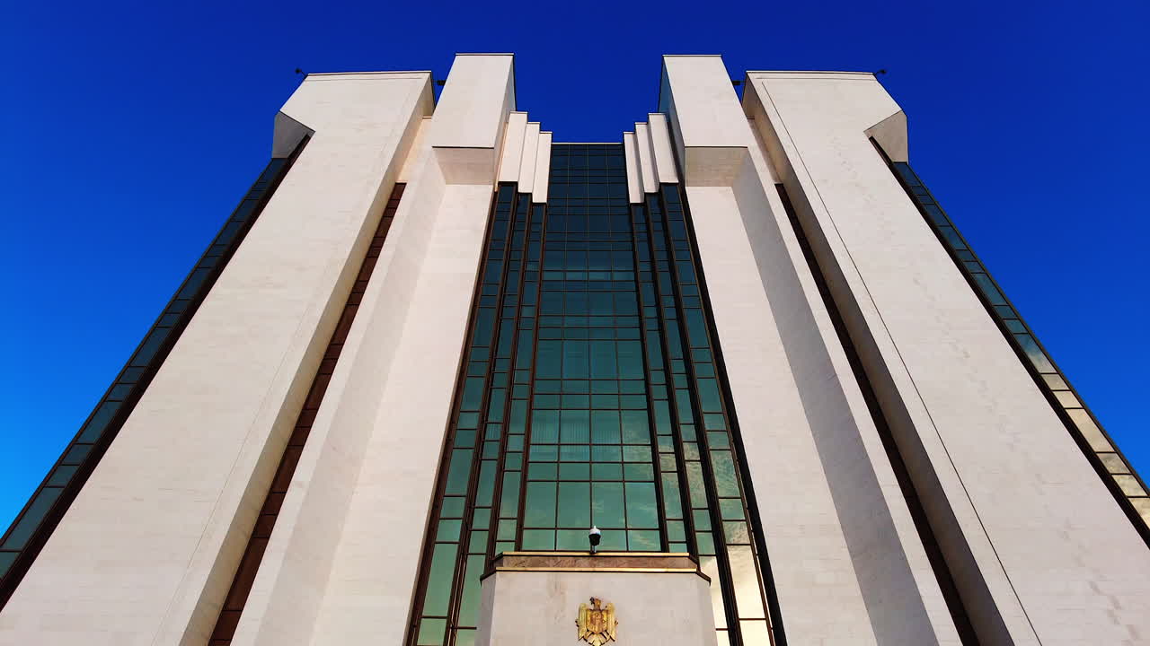 Chisinau, Moldova - December 23, 2021: A visual tour showcases the impressive structure of the Presidential Palace in Chisinau, Moldova, highlighting its architectural design against a sunset backdrop