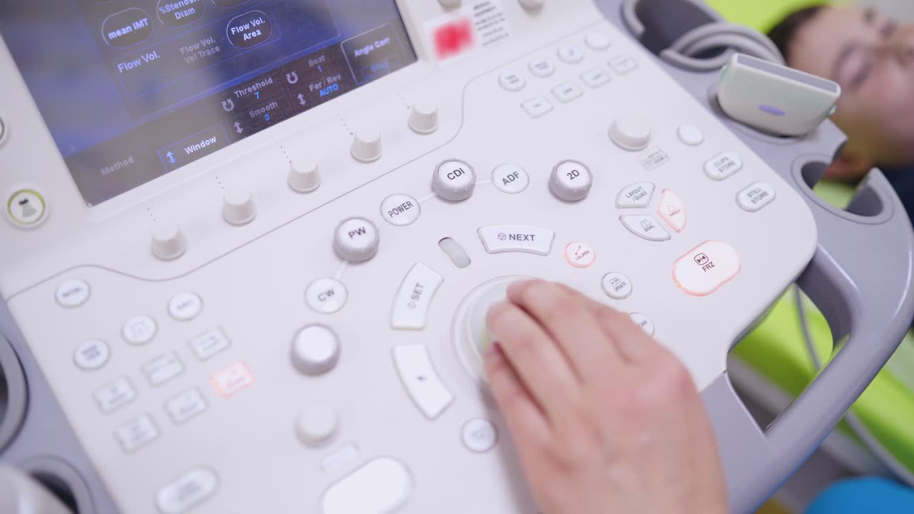 Modern ultrasound machine. Doctor presses buttons on ultrasound machine during making the diagnostics of a patient in clinic. Close-up.