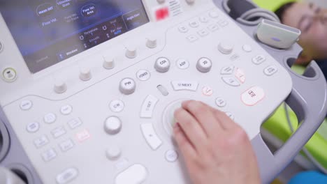 modern ultrasound machine. doctor presses buttons on ultrasound machine during making the diagnostics of a patient in clinic. close-up.