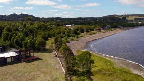 Aerial-Drone-Flyover-Huillinco-Lake-Waterfront-Park-Landscape,-Chile-Chiloe,-4K