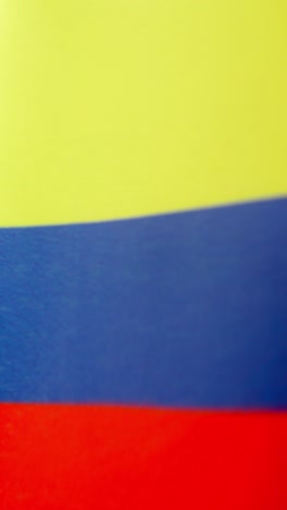 vertical video of colombian national flag waving by the wind