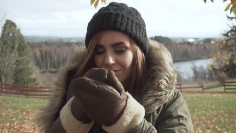 Front-view-of-girl-drinking-warm-beverage-in-cold-autumn-day