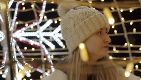 woman watching christmas lights on a great exhibition