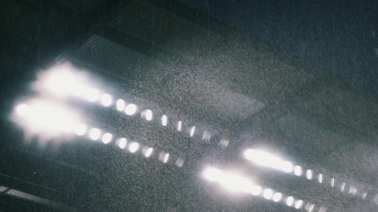 Stadium lights with pouring rain in slow motion