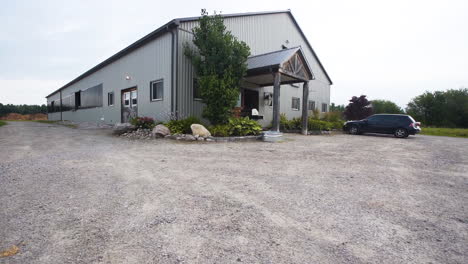exterior of a gray horse stable on a farm
