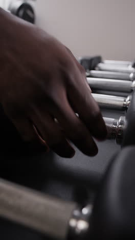 person handling dumbbells