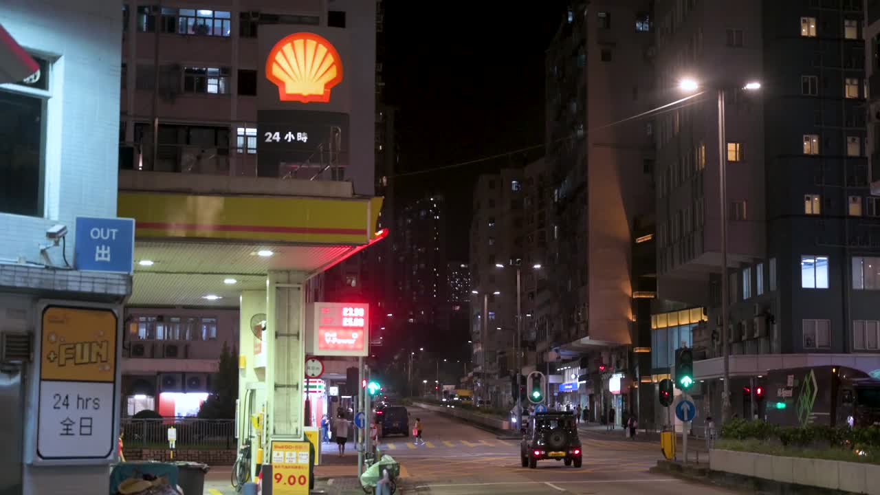 Night scene of a Shell gas station and busy city street