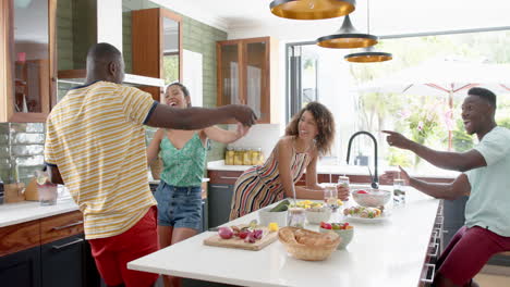 diverse group enjoys a dance in a bright kitchen