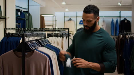 man shopping for clothes in a retail store
