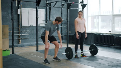 man weightlifting with personal trainer